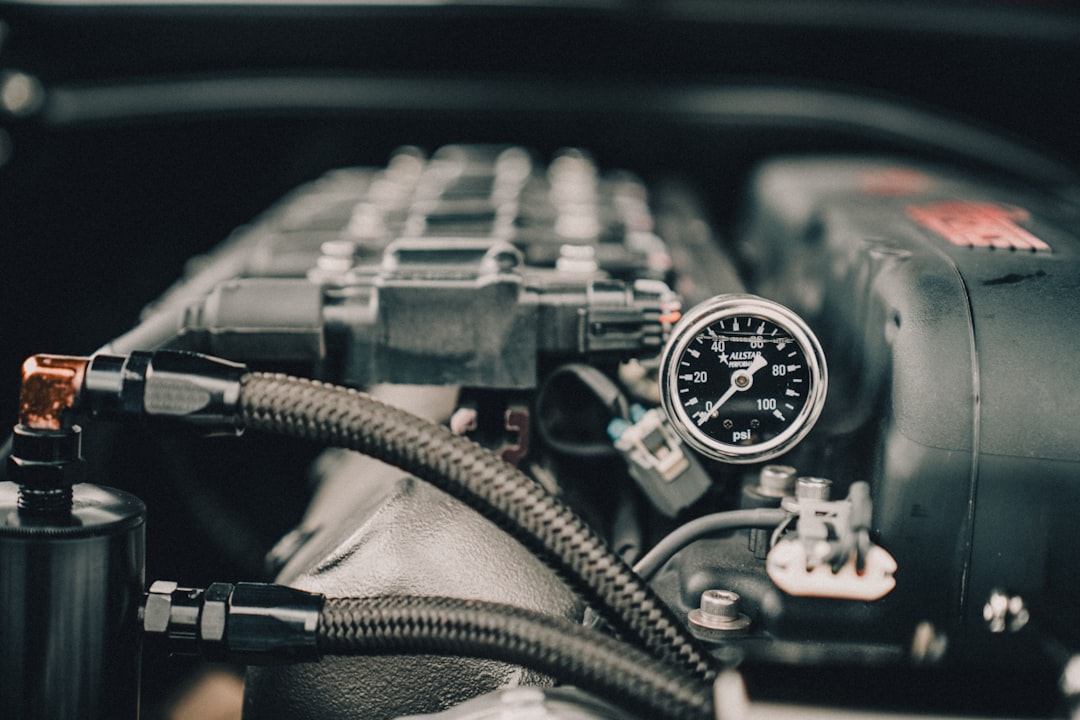 Vehicle air conditioning service gauge connected in an engine bay