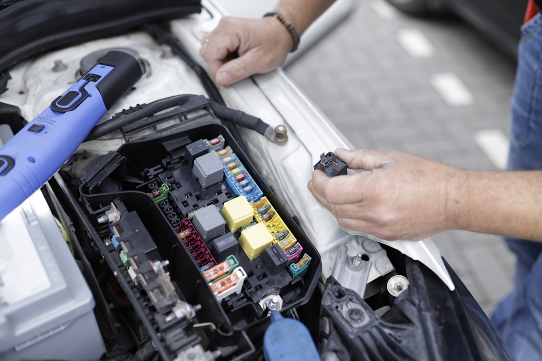 Technician working on vehicle electrical systems